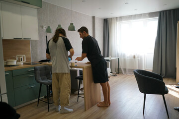 Two friends engage in a lively conversation while preparing food