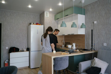 Two friends engage in a lively conversation while preparing food