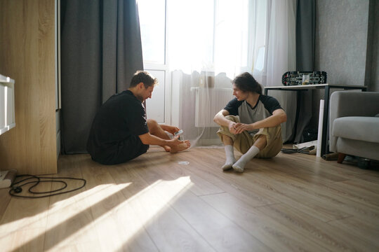 Friends enjoy a lively poker game on the floor in a bright, modern living room