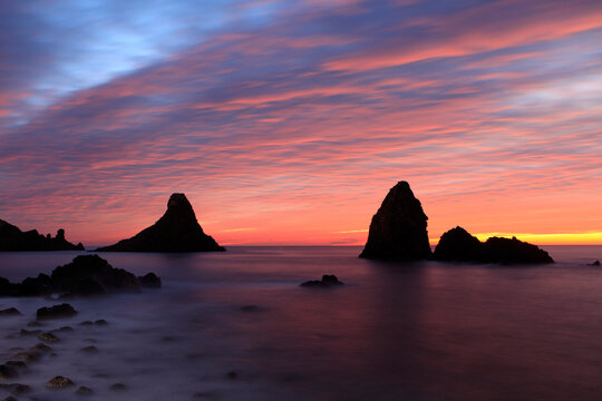 Cyclops stacks in Aci Trezza at sunrise, Sicily, Italy