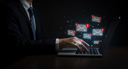 Businessperson using laptop checking email notifications dark background