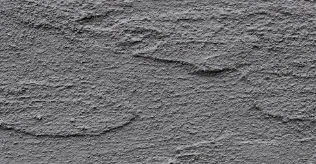 Rough cement wall with a weathered, grunge texture. Abstract and aged surface, showcasing worn
