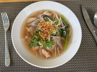 Traditional Thai Chicken Rice Noodle Soup with Bean Sprouts and Herbs