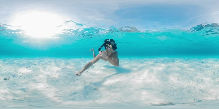 VR 360 Underwater panorama of the man swimming in the tropical sea with perfect sandy bottom