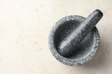 Stone mortar and pestle on light table, top view. Space for text