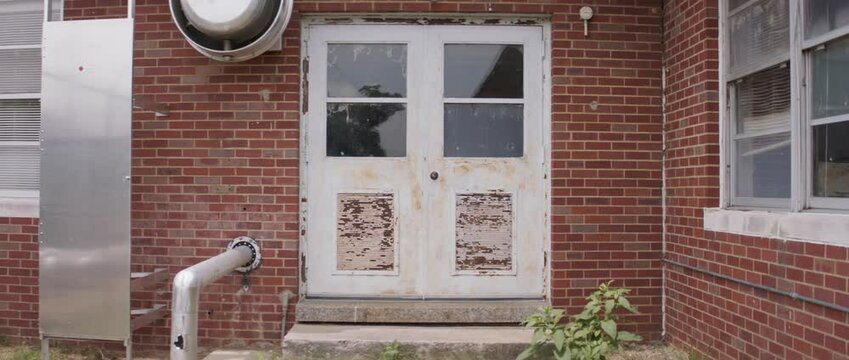 Old building entrance with peeling paint and rust