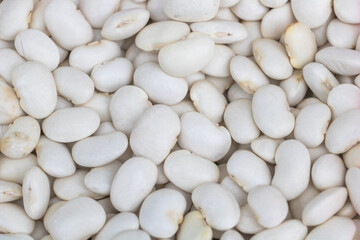 White beans, close-up of white bean texture background. White legumes for healthy food and...
