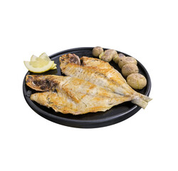 Grilled fish with potatoes and lemon on a black plate