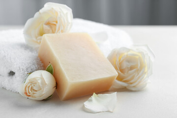 Aromatic soap bar and roses on light table