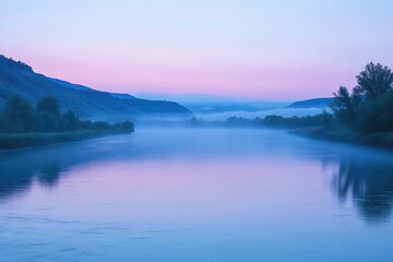 Fototapeta premium A serene river scene unfolds at dawn, with mist hanging low and mountains silhouetted against a soft pink and blue sky.