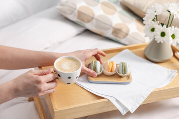 Woman having delicious breakfast in bed, closeup