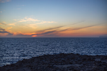 The rugged cliffs of Blata tal-Melh on the coast of Malta during spectacular dramatic sunset.
