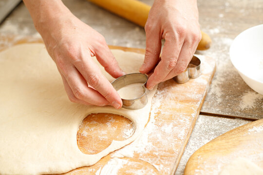 Making Heart Shaped Cookies for Loves Day. Close-up of male hands. Baking concept.