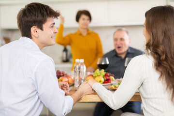 Happy family having dinner together at the festive table at home