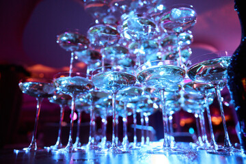 Champagne Glass Pyramid at Party with Neon Lights
