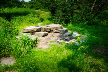 Firepit with bench and Rock Seats near a little River in the bavarian Forests Germany