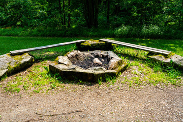 Firepit with bench and Rock Seats near a little River in the bavarian Forests Germany