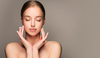 Beautiful young woman with clean fresh skin on face . Girl facial  treatment   . Cosmetology , beauty  and spa .
