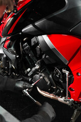 Motorcycle crankcase inspection with ratchet wrench ensures performance efficiency. Mechanic...