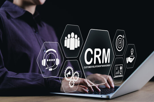 CRM Customer Relationship Management Concept. A business professional working on laptop with CRM icons, representing customer service, analytics, engagement, and relationship management tools.