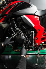 Motorcycle crankcase inspection with ratchet wrench ensures performance efficiency. Mechanic...