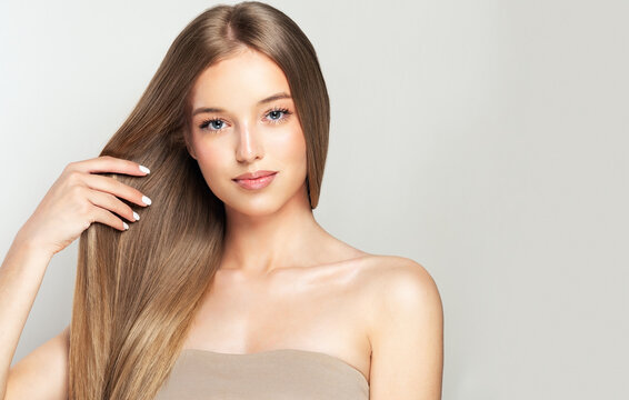 Fototapeta Beautiful model girl with shiny blonde and straight long  hair . Keratin  straightening . Treatment, care and spa procedures. Smooth hairstyle. 