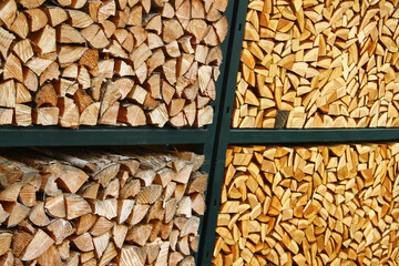 Stacked firewood in metal rack with contrasting wood tones