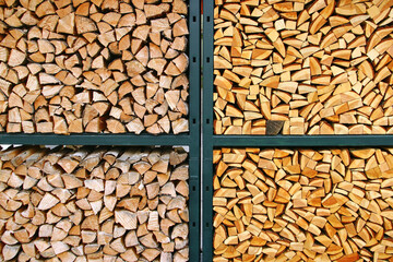 Stacked firewood in metal rack with contrasting wood tones