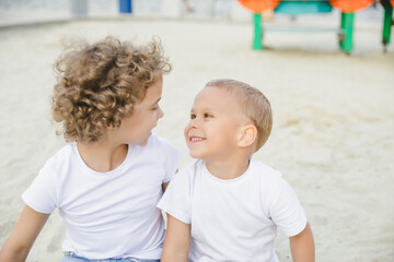 portrait of a boy and a girl, brother and sister. brother and sister looking at each other sweetly