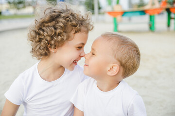 portrait of a boy and a girl, brother and sister. brother and sister looking at each other sweetly