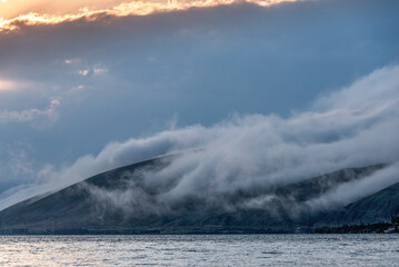 Beautiful sunset with clouds over the lake.