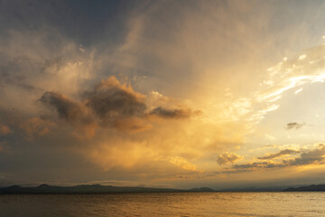 Beautiful sunset with clouds over the lake.