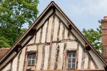 Gable End of Half-Timbered Building with Windows and Chimney  in Giverny, France.