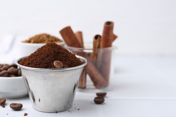 Instant coffee powder and beans on light table, selective focus. Space for text