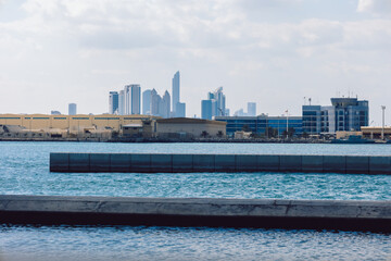 View of city with towers and skyscrapers from Saadiyat Island in Abu Dhabi, United Arab Emirates. View from water surface. High quality photo