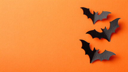 Halloween background with black paper bats and copy space