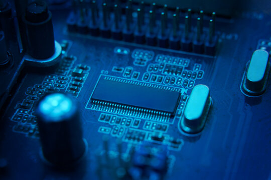 Here is a detailed view of a bluelit circuit board that showcases intricate and complex electronic components