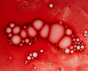 Beautiful texture of cosmetic serum on red background