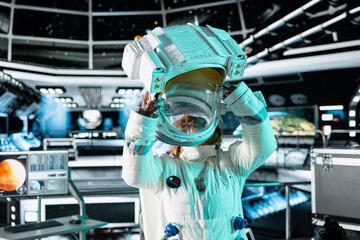 Female scientist putting on helmet in cutting edge spaceship doing cosmic voyage in solar system....