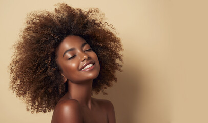 Beauty portrait of african american woman with clean healthy skin on beige background. Smiling dreamy beautiful afro haitstyle girl.Curly black hair