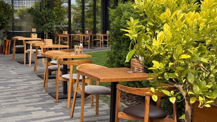 summer cafe in the park, wooden tables, green grass, glass, a place for outdoor recreation