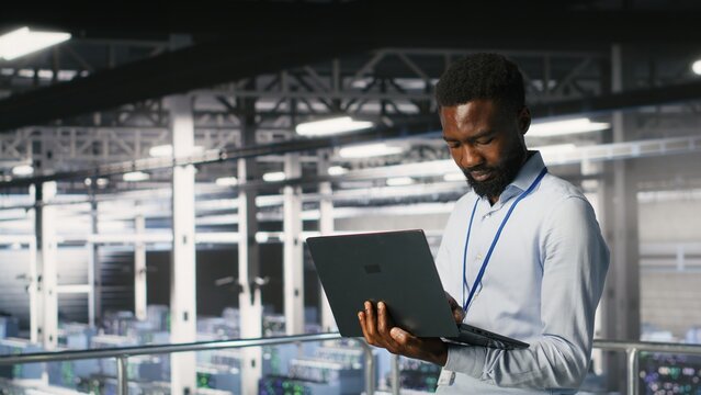 Data center engineering team on industrial platform collaborating to maintain blade servers. Technicians coordinating infrastructure tasks to support machine learning automatization of infrastructure - Powered by Adobe