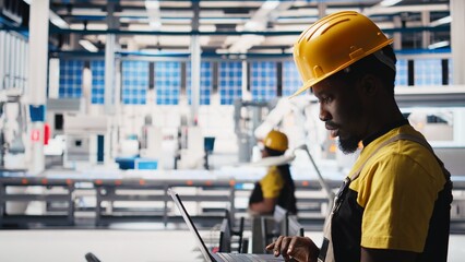 Engineer using laptop to monitor solar panel plant assembly lines, troubleshooting photovoltaic equipment to ensure seamless production workflow. Automation for alternative energy. Camera B.