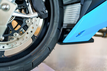 Close-up view of a motorcycle wheel showcasing intricate details, technology, and precision in...