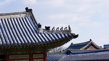 Closeup of a traditional Korean roof ridge design and ornamentation