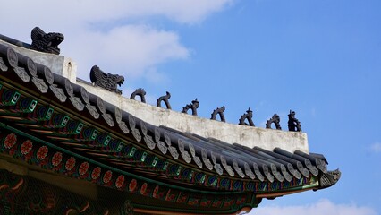 Closeup of a traditional Korean roof ridge design and ornamentation