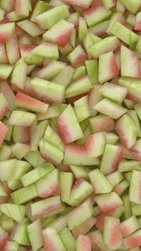 Peeled watermelon rind chunks background texture. Watermelon rind is edible after heat treatment (stir-fry, braise, or cook). Zero waste food concept. 