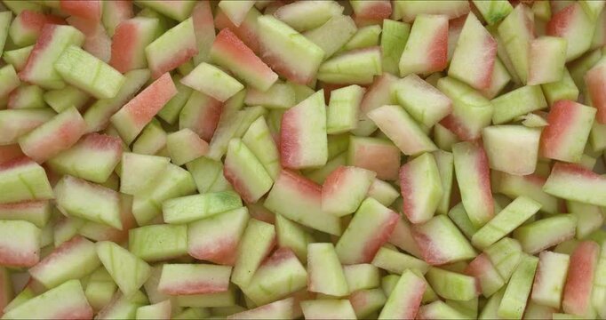 Peeled watermelon rind chunks background texture. Watermelon rind is edible after heat treatment (stir-fry, braise, or cook). Zero waste food concept. 