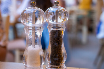 Glass Salt and Pepper Grinders on a Restaurant Table