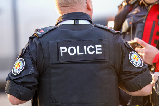Toronto police officer uniform back POLICE text, Calgary, Alberta, Canada, June 15, 2025